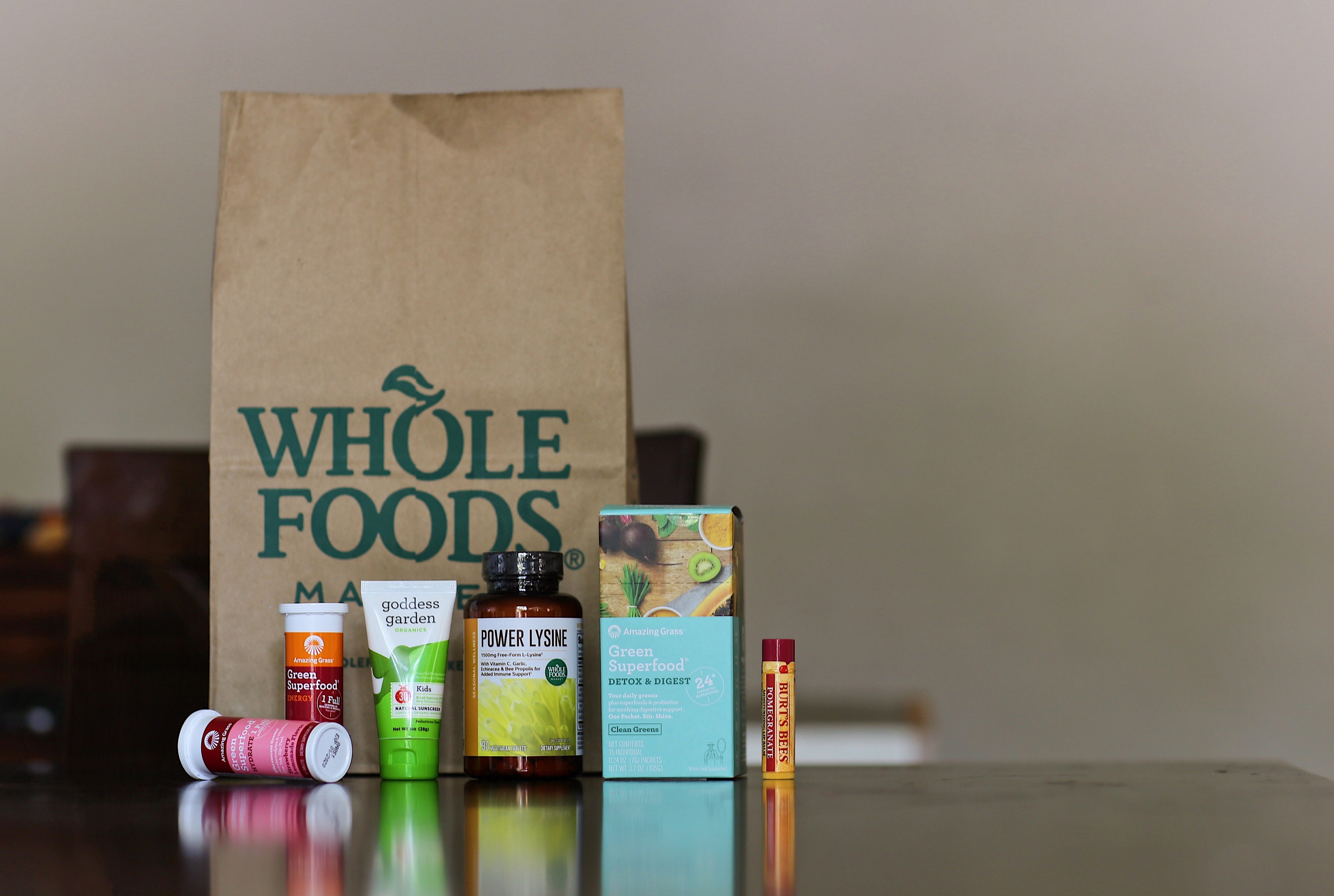A whole foods bag and assorted health supplements