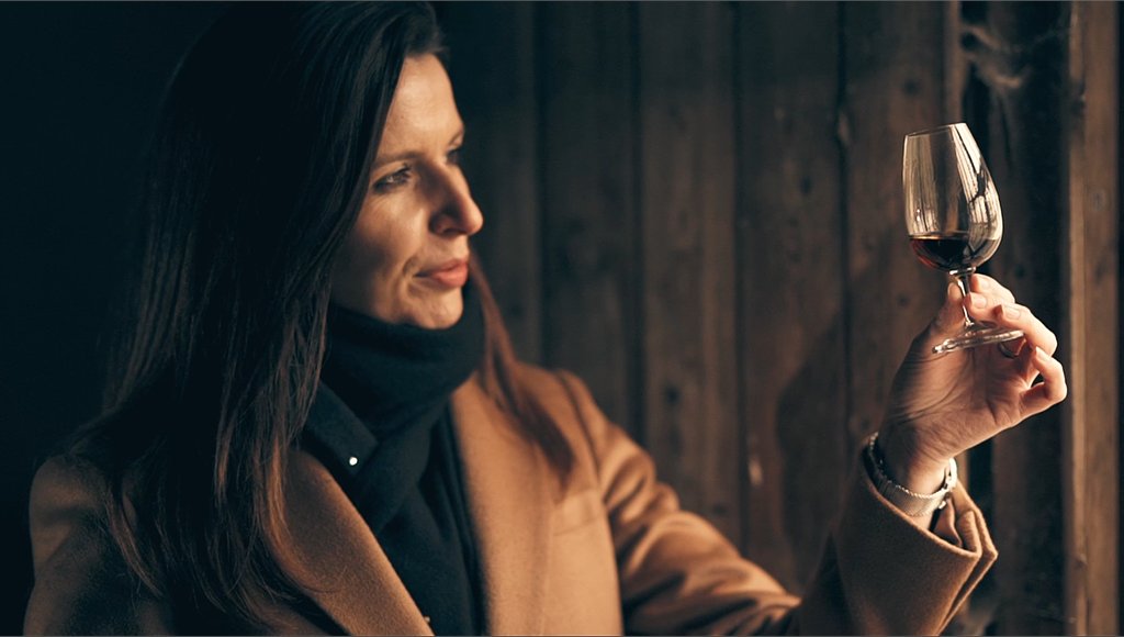 A photo of Macallan Master Whisky Maker Kirsteen Campbell looking at a glass of whisky