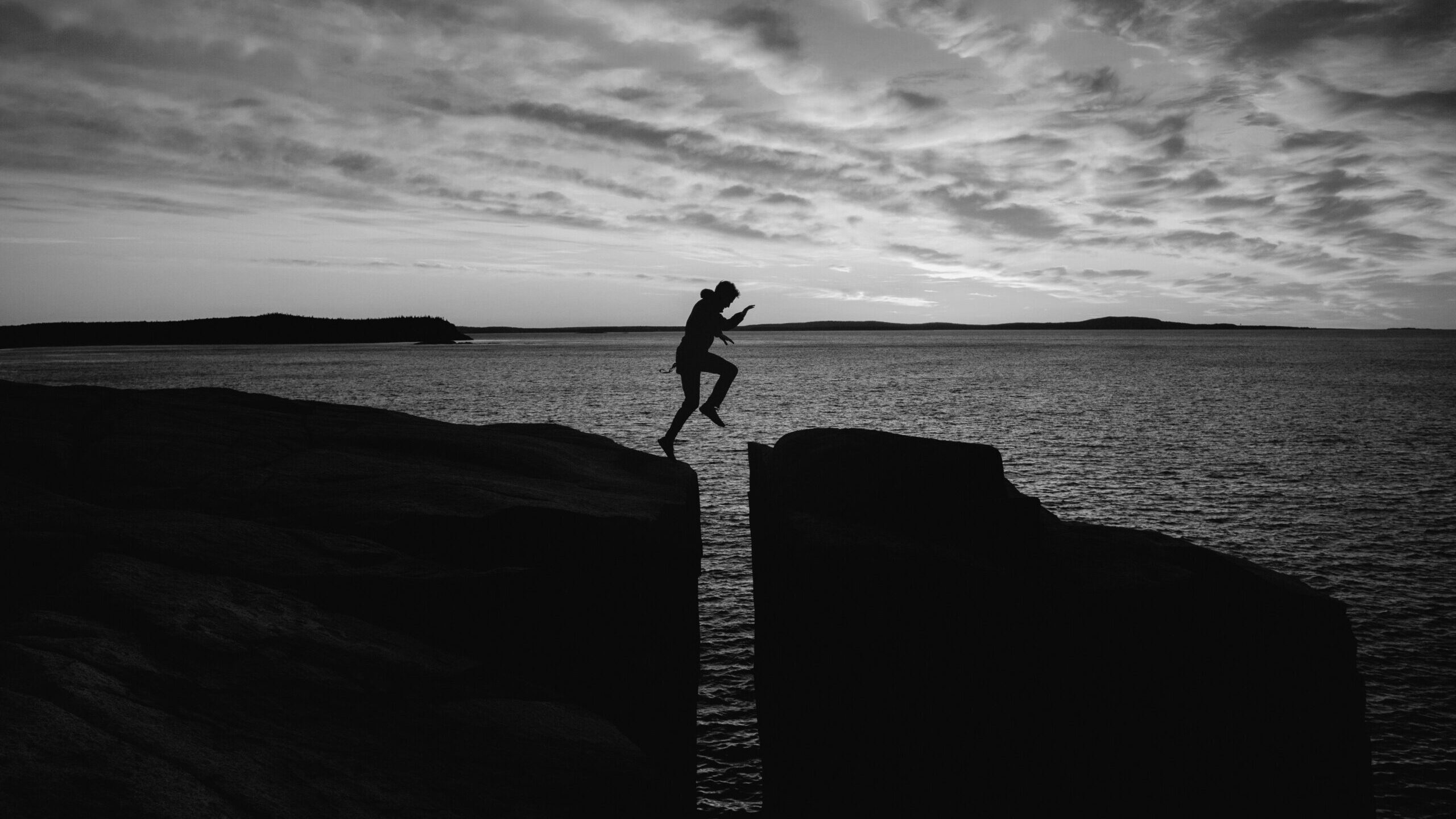 Experience Gap - Man jumping over gap between rocks